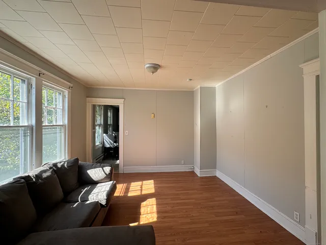 a living room with furniture and large windows