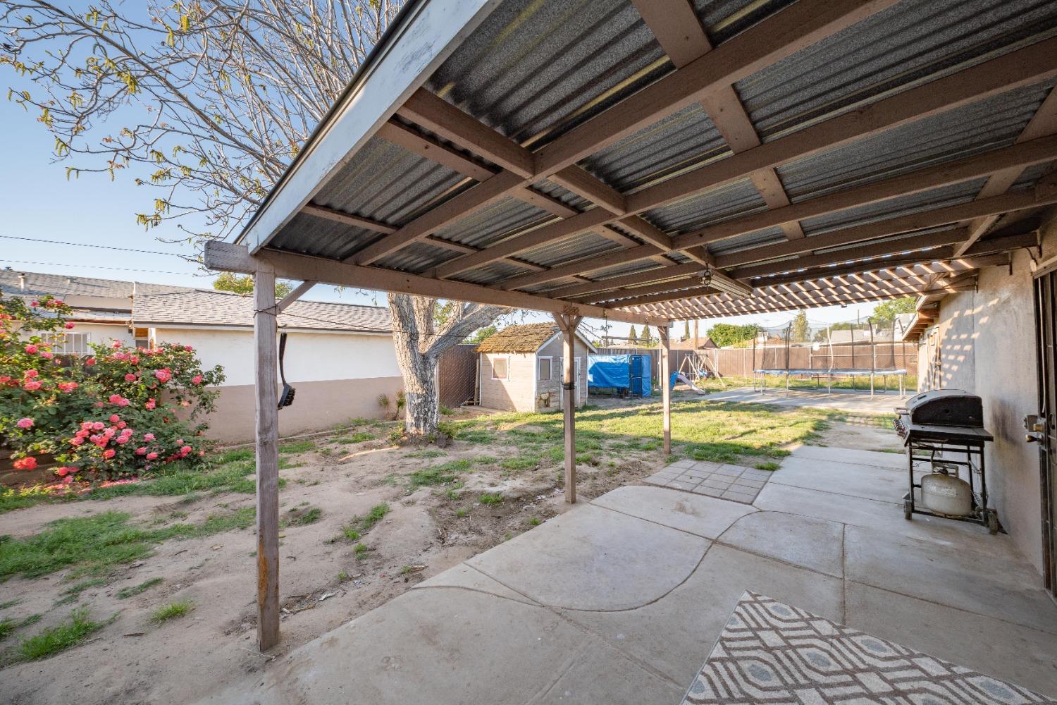 836 North E Street Tulare, CA 93274 - Photo 13 of 13 a view of a swimming pool with a patio