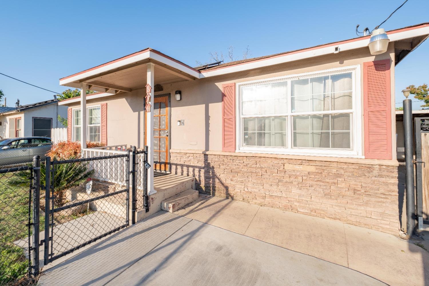 836 North E Street Tulare, CA 93274 - Photo 2 of 13 a view of a house with backyard and porch