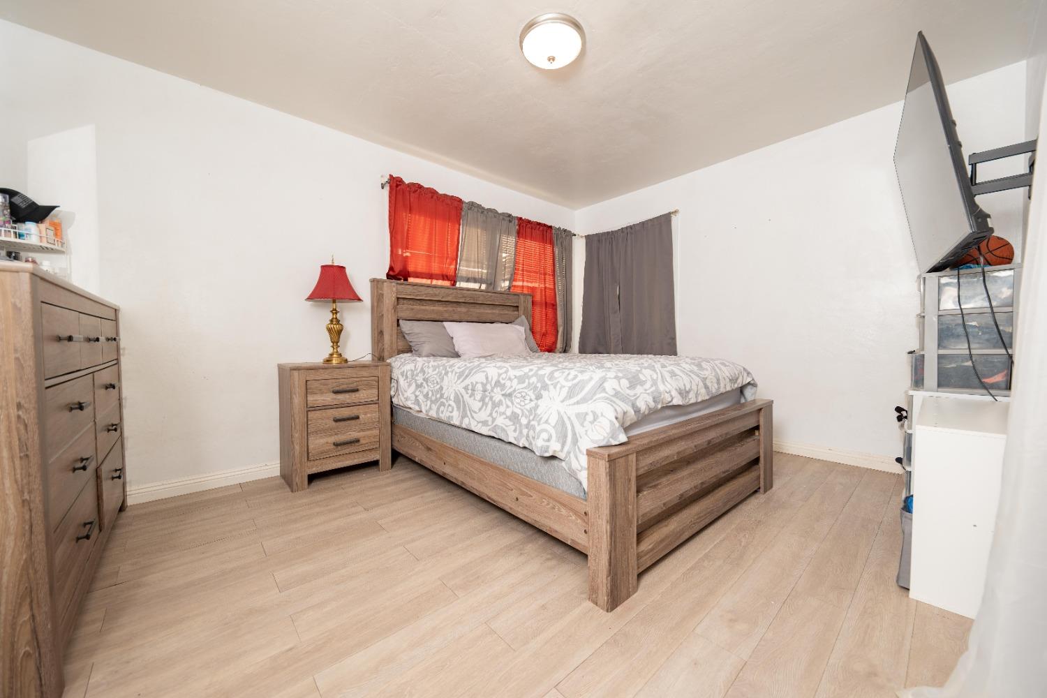 836 North E Street Tulare, CA 93274 - Photo 6 of 13 a bedroom with a bed and a window