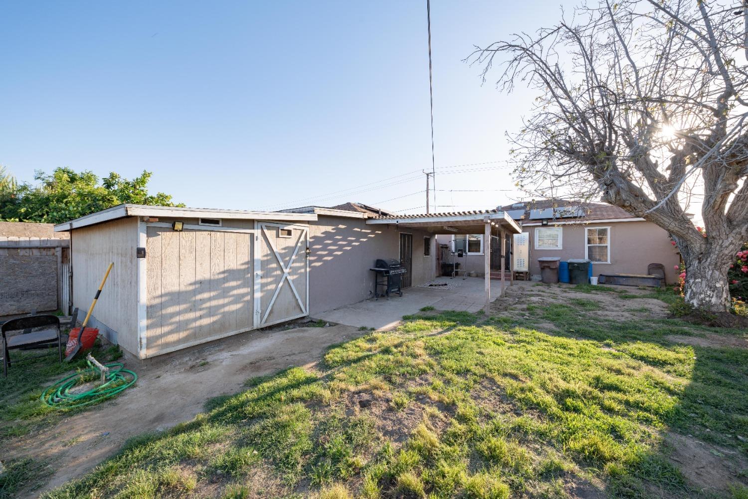 836 North E Street Tulare, CA 93274 - Photo 9 of 13 a view of a house with backyard and sitting area