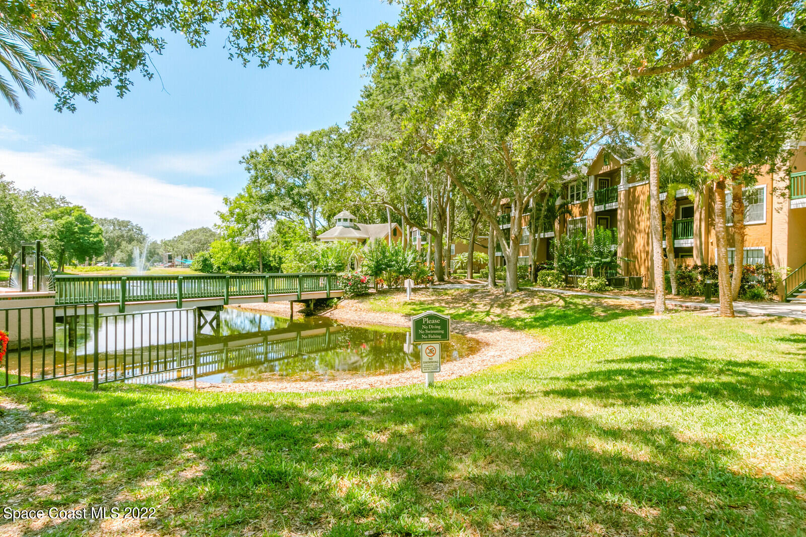 7667 North Wickham Road, Unit 418 Melbourne, FL 32940 - Photo 19 of 36 a view of yard with swimming pool and green space