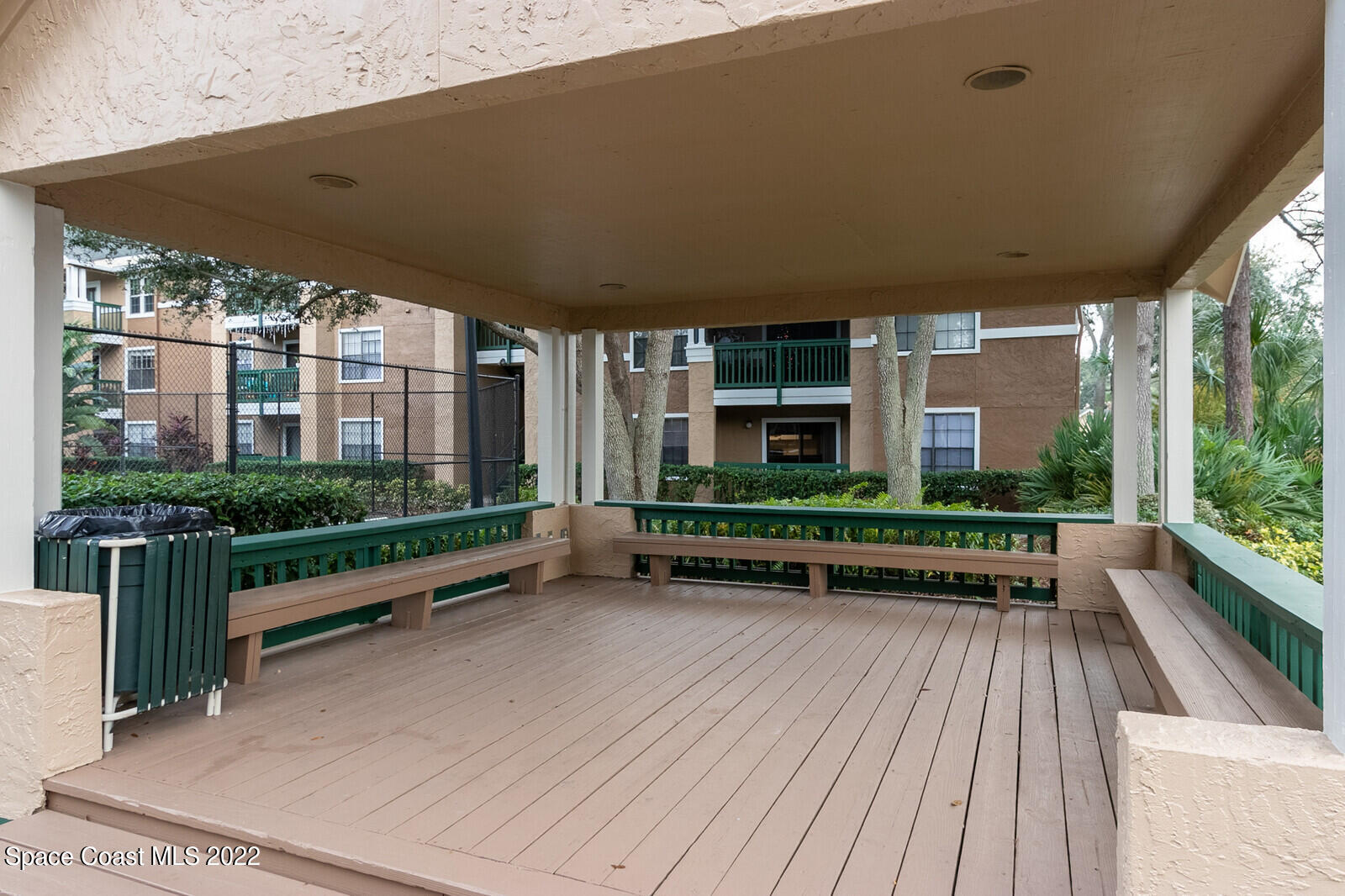 7667 North Wickham Road, Unit 418 Melbourne, FL 32940 - Photo 25 of 36 a view of balcony with couch and wooden floor