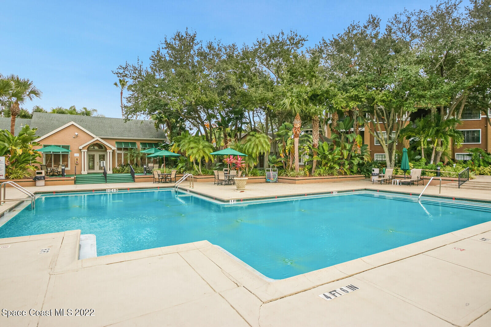 7667 North Wickham Road, Unit 418 Melbourne, FL 32940 - Photo 34 of 36 a view of swimming pool with outdoor seating and trees in the background