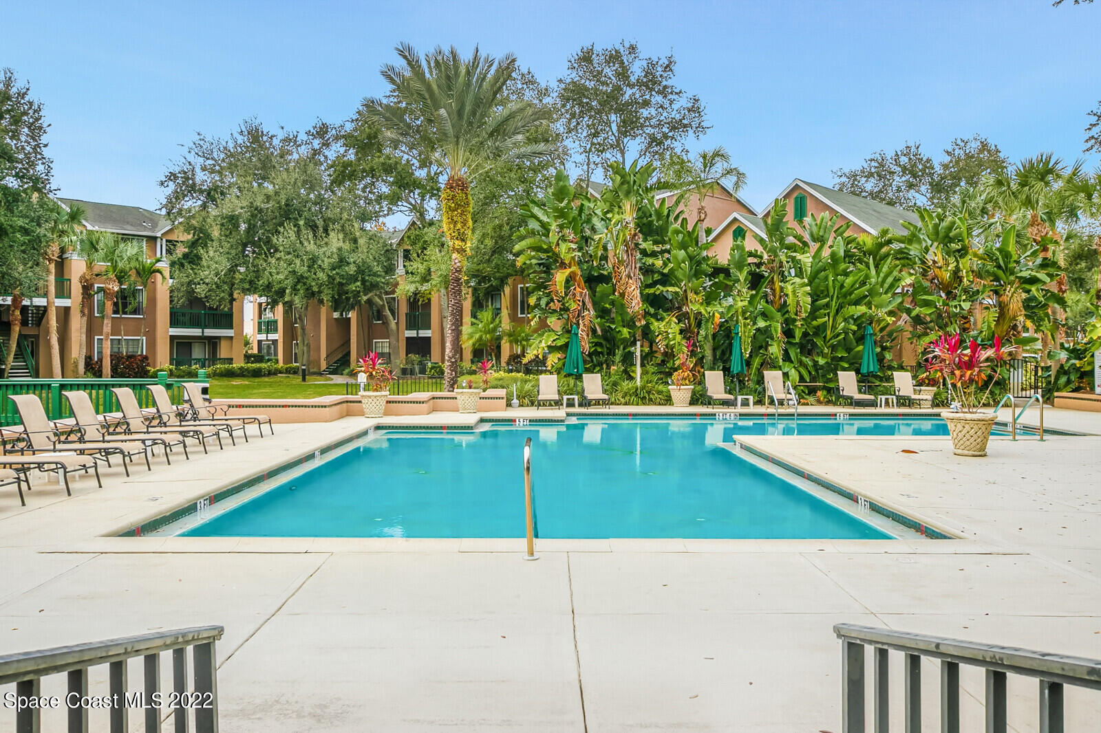 7667 North Wickham Road, Unit 418 Melbourne, FL 32940 - Photo 36 of 36 a view of a swimming pool with an outdoor space and seating area