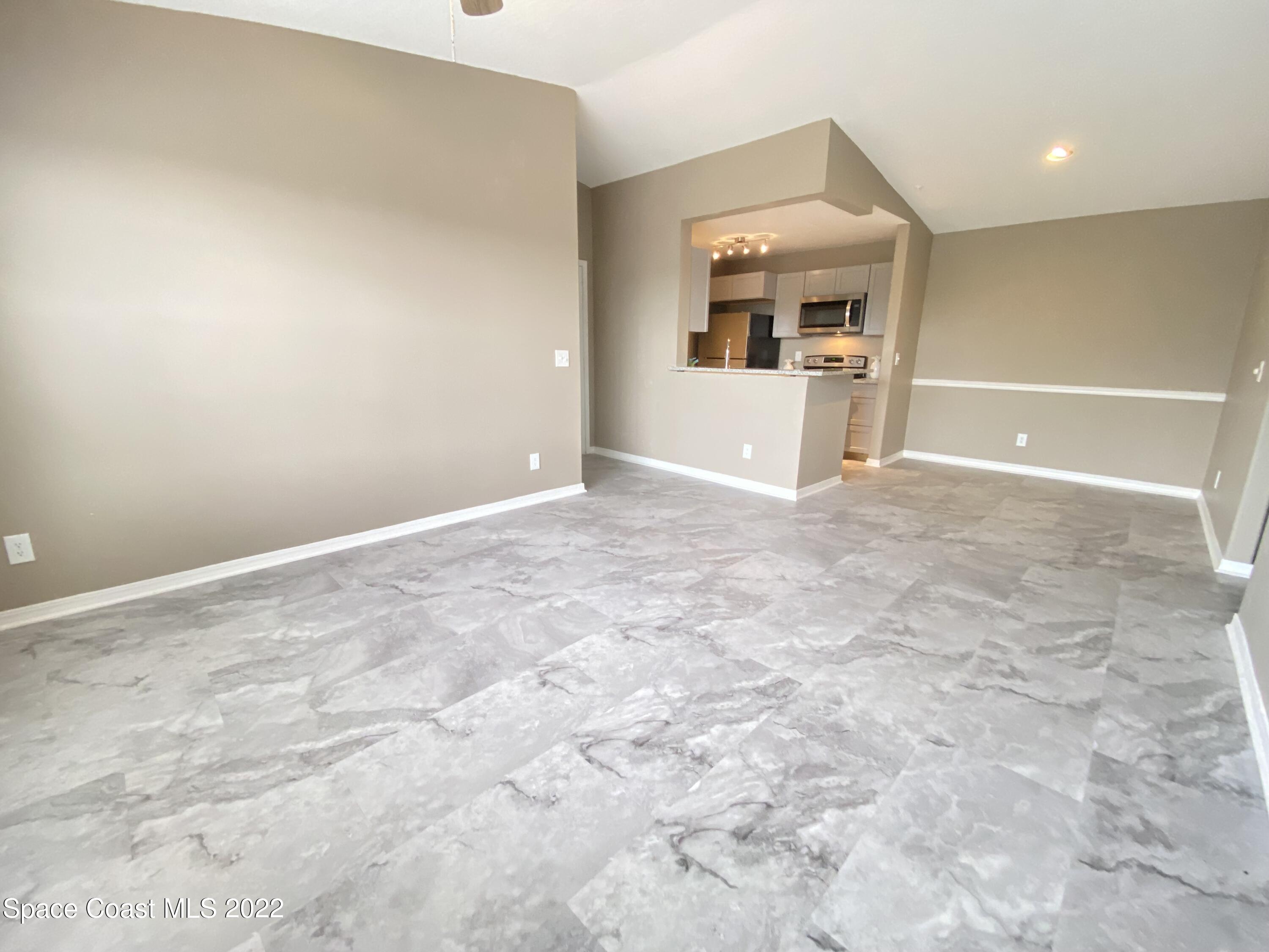 7667 North Wickham Road, Unit 418 Melbourne, FL 32940 - Photo 6 of 36 a view of a kitchen with furniture and a kitchen