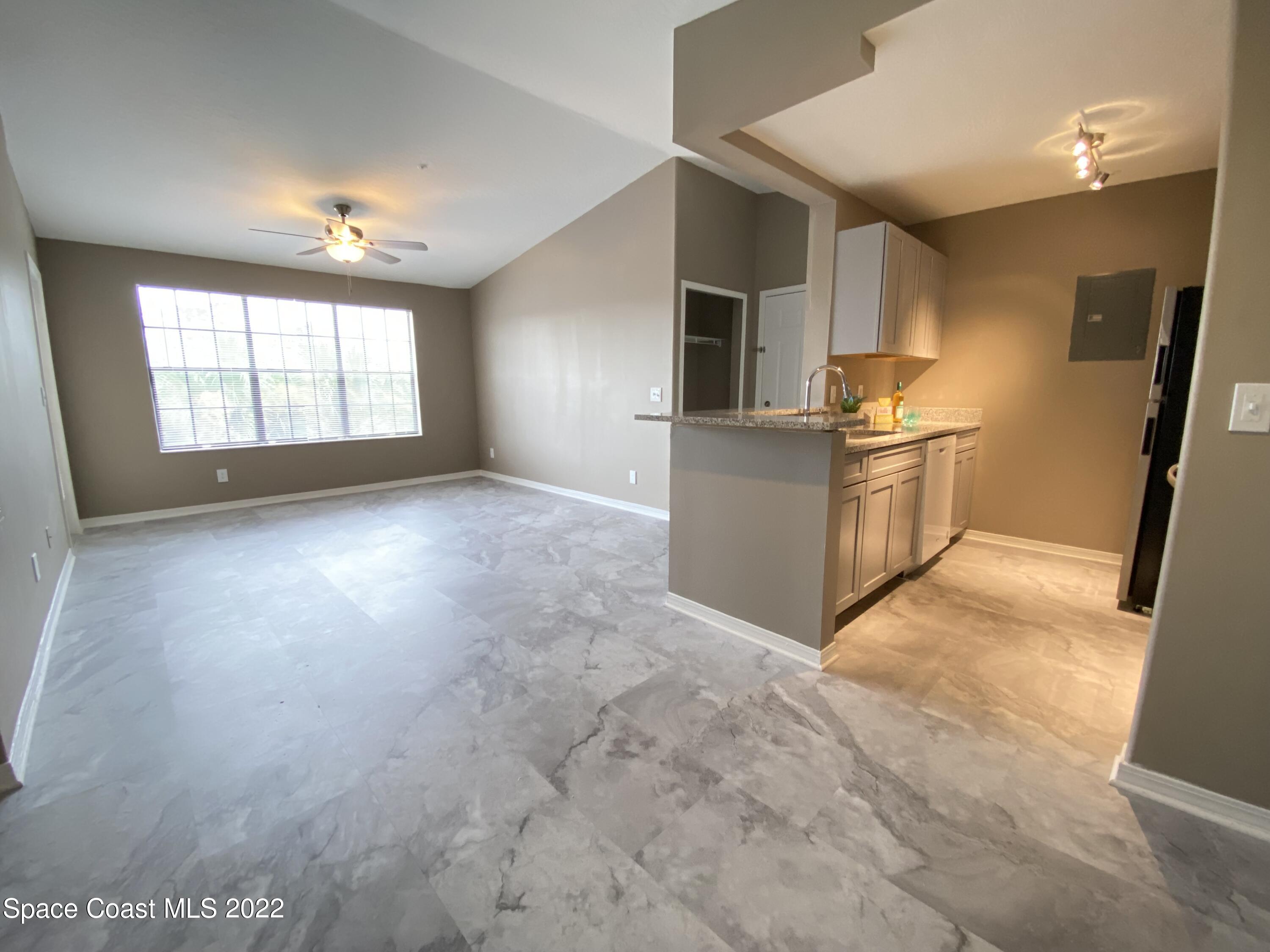 7667 North Wickham Road, Unit 418 Melbourne, FL 32940 - Photo 7 of 36 a view of a kitchen with furniture and a window