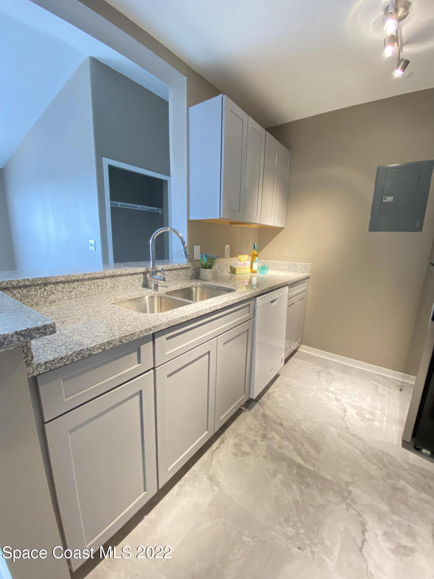 7667 North Wickham Road, Unit 418 Melbourne, FL 32940 - Photo 10 of 36 a kitchen with a sink and cabinets