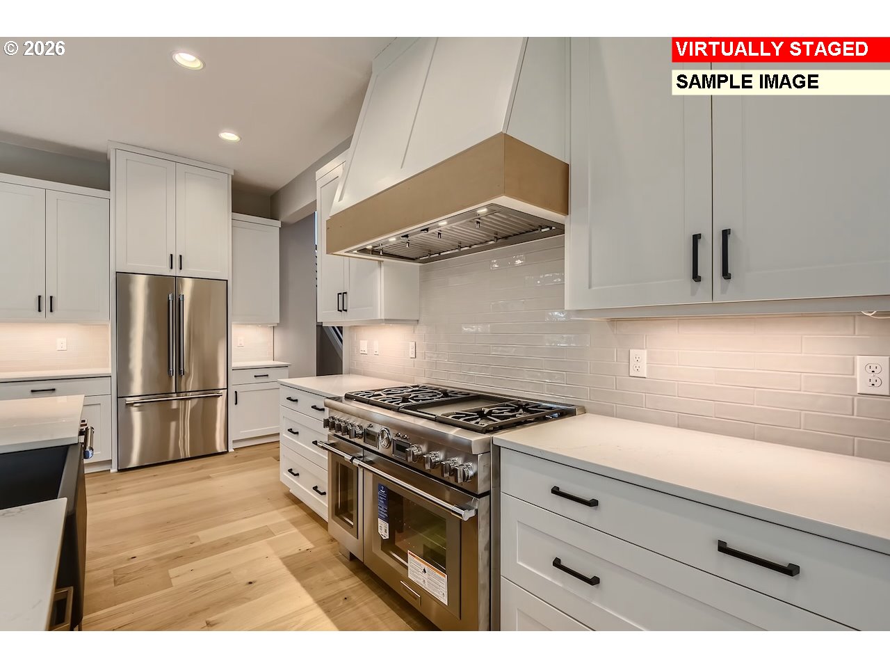 7975 Southwest 82nd Avenue Portland, OR 97223 - Photo 5 of 7 a kitchen with stainless steel appliances white cabinets and wooden floor