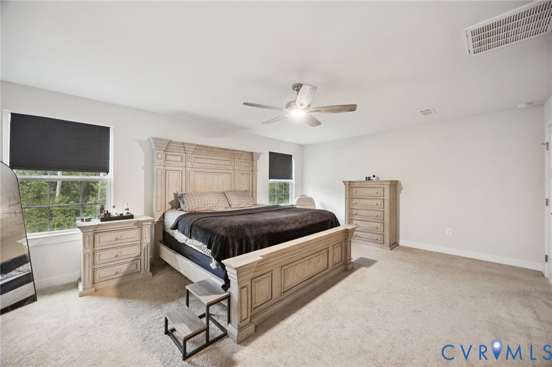 10237 Centralia Sta Road Chester, VA 23831 - Photo 17 of 35 a spacious bedroom with a bed and a large window