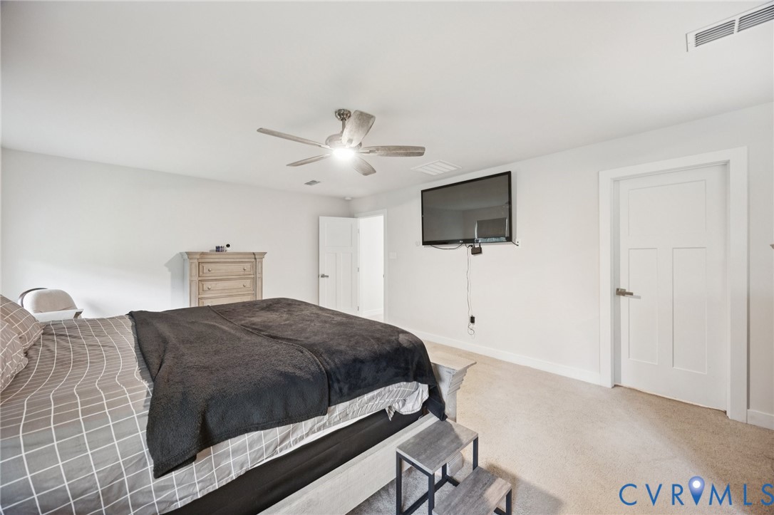 10237 Centralia Sta Road Chester, VA 23831 - Photo 18 of 35 a bedroom with a bed and a flat tv screen on dresser