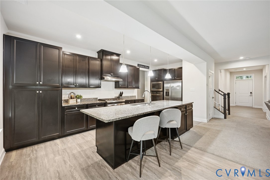 10237 Centralia Sta Road Chester, VA 23831 - Photo 8 of 35 a kitchen with kitchen island granite countertop wooden cabinets and refrigerator