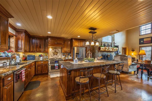 a kitchen with lots of counter top space and furniture