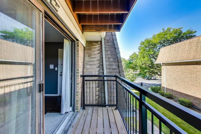 a view of balcony with wooden floor and fence