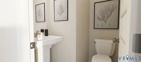 a white toilet sitting next to a bathroom sink