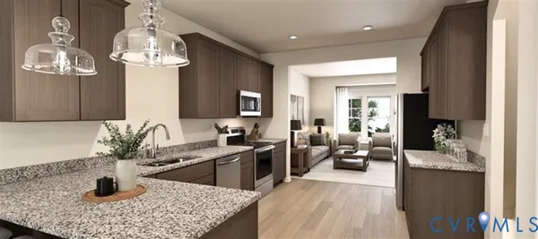 a kitchen with a sink dishwasher a stove and a refrigerator with wooden floor