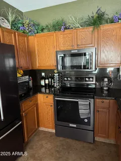 a kitchen with stainless steel appliances wooden cabinets and a stove top oven