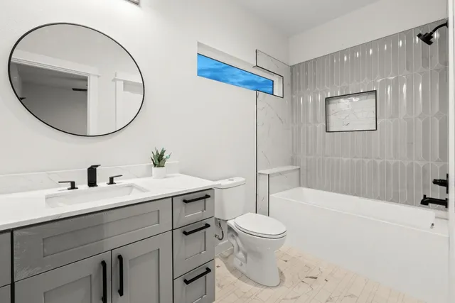 a bathroom with a sink a toilet and a mirror