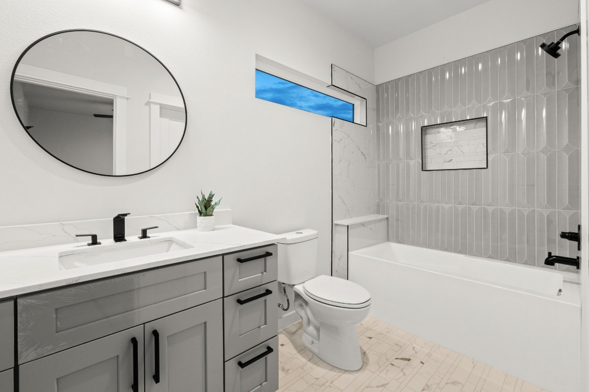 2309 Montopolis Drive, Unit 3 Austin, TX 78741 - Photo 15 of 35 a bathroom with a sink a toilet and a mirror