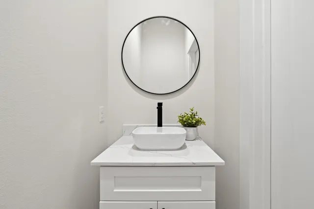 a bathroom with a sink and a mirror