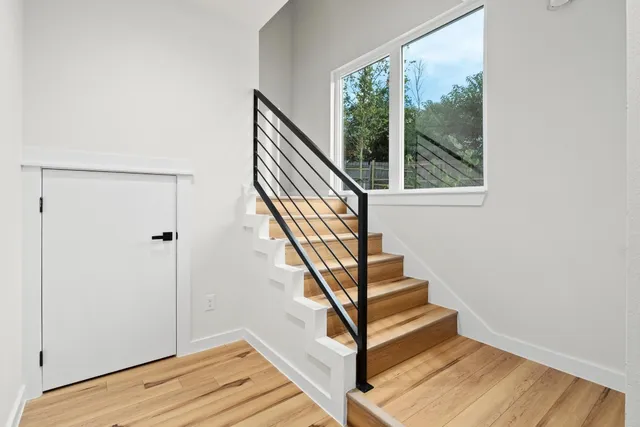 a view of entryway and hall with wooden floor