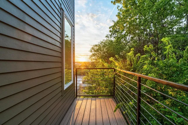 a view of balcony with wooden floor and fence