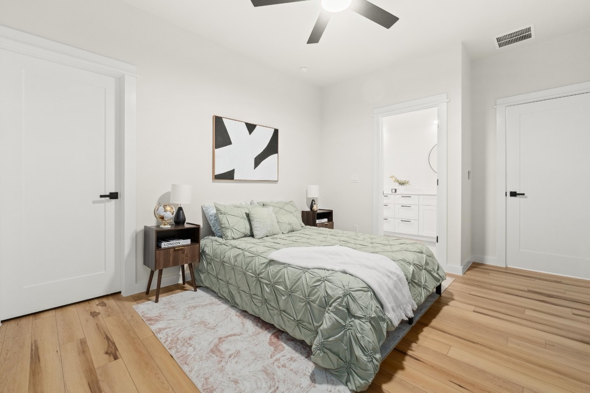 2309 Montopolis Drive, Unit 3 Austin, TX 78741 - Photo 33 of 35 a bedroom with a bed and a chandelier