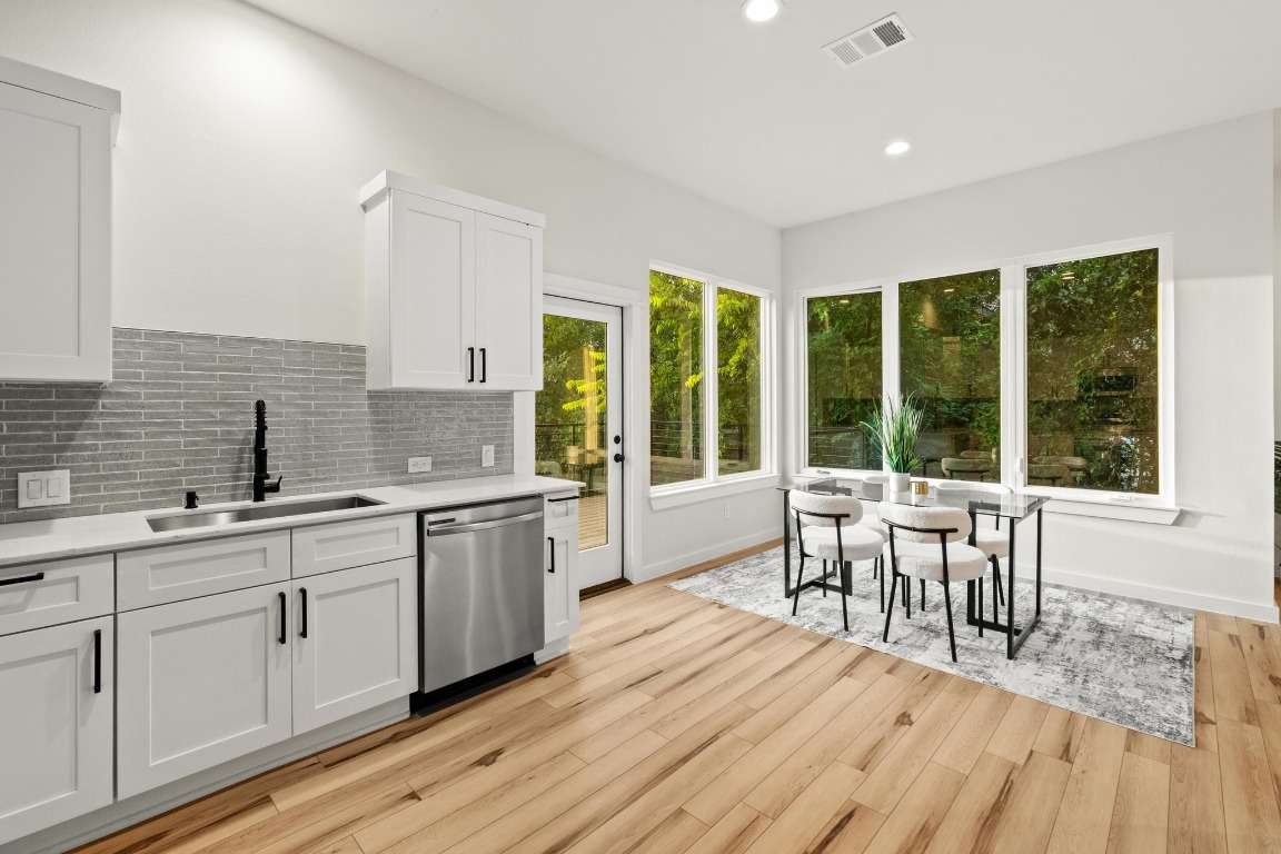 2309 Montopolis Drive, Unit 3 Austin, TX 78741 - Photo 7 of 35 a view of a kitchen with a sink and wooden floor