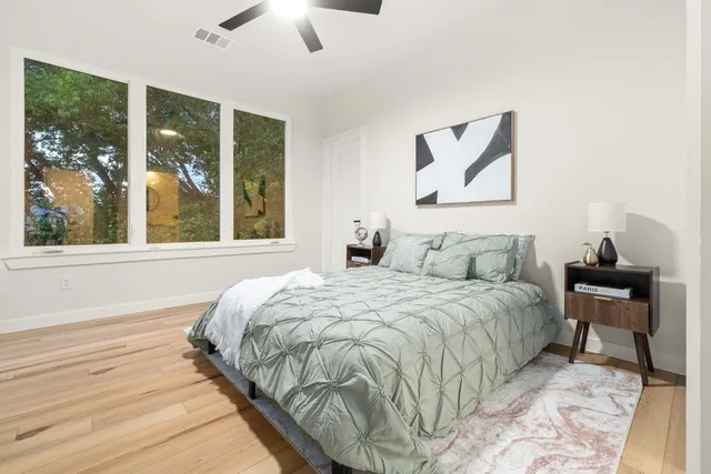a bed sitting in a bedroom next to a window