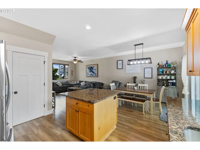 a kitchen with stainless steel appliances granite countertop a stove and a refrigerator