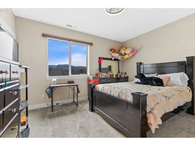 a bedroom with bed and window