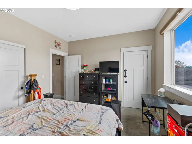 a bed room with a bed and a desk