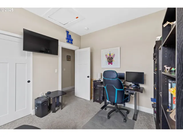 a work room with furniture and a flat screen tv