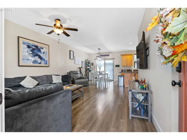 a living room with furniture and wooden floor