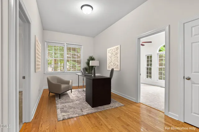 an empty room with windows and ceiling fan