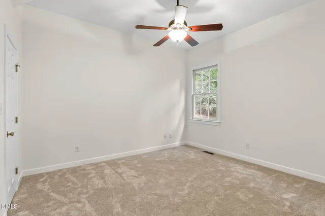 a view of a kitchen with refrigerator and wooden floor