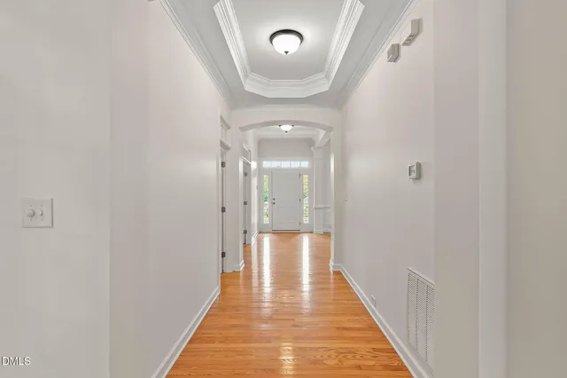 a view of empty room with wooden floor and fireplace
