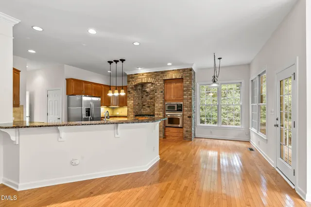 a kitchen with granite countertop cabinets stainless steel appliances and a counter top space