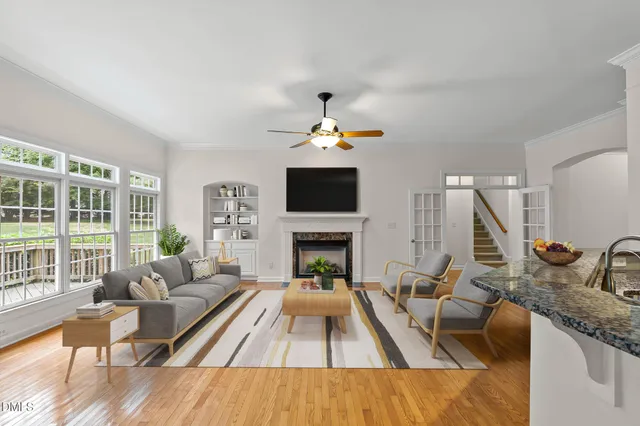 a kitchen with stainless steel appliances granite countertop a sink a refrigerator and a wooden floors