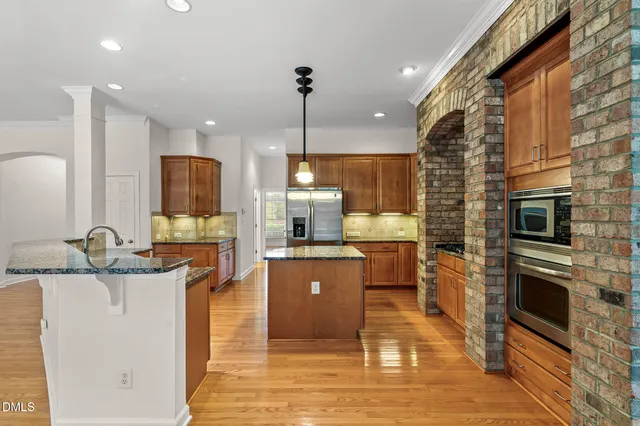 a bedroom with a large bed and a chandelier