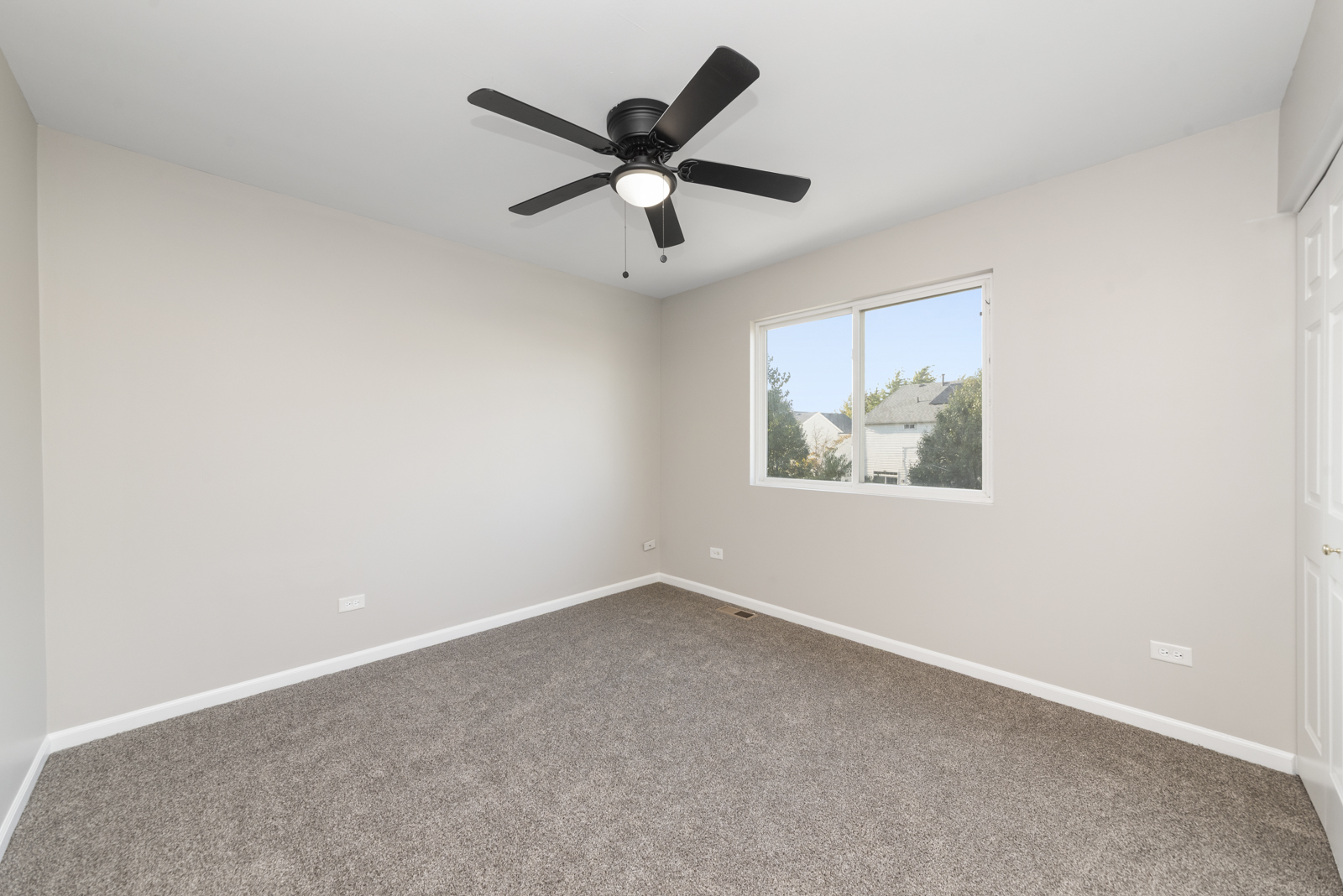 6407 Coyote Ridge Court Plainfield, IL 60586 - Photo 11 of 24 an empty room with ceiling fan and window