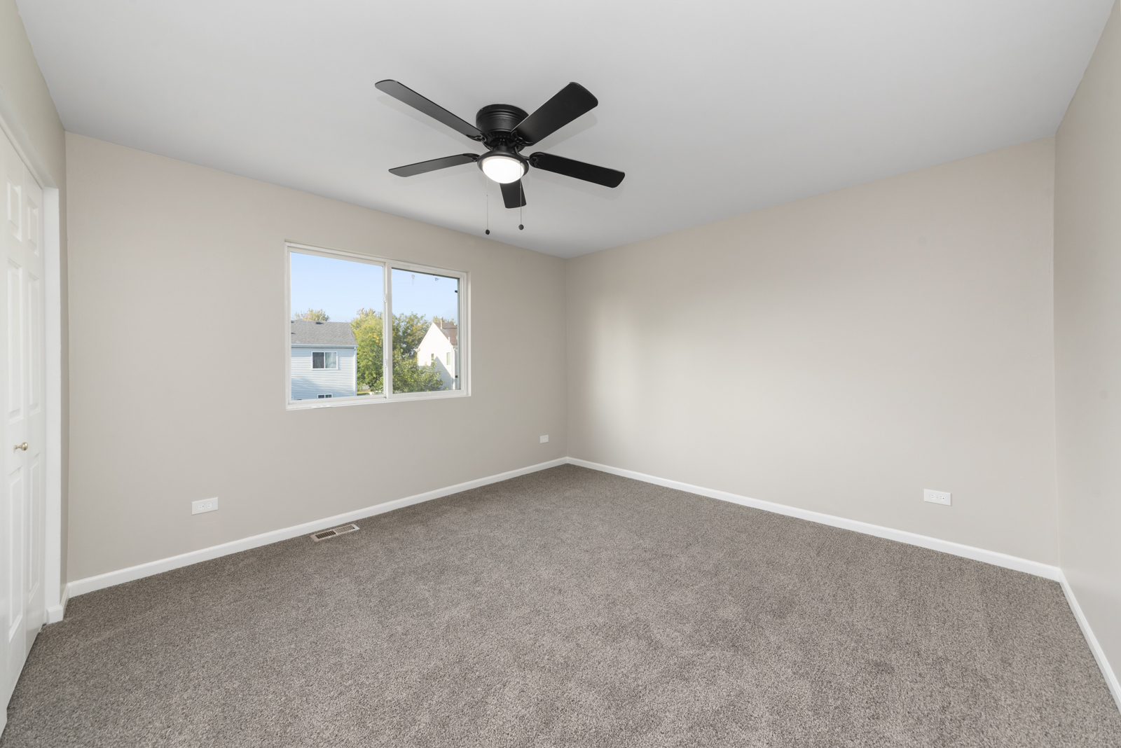 6407 Coyote Ridge Court Plainfield, IL 60586 - Photo 12 of 24 an empty room with a window and a fan