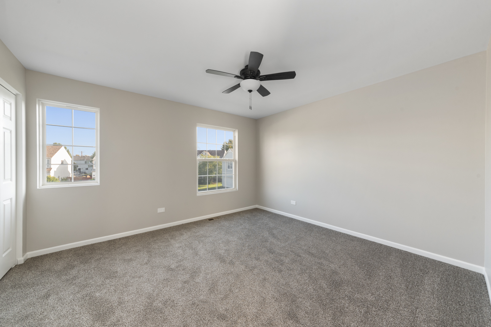6407 Coyote Ridge Court Plainfield, IL 60586 - Photo 14 of 24 an empty room with windows and fan