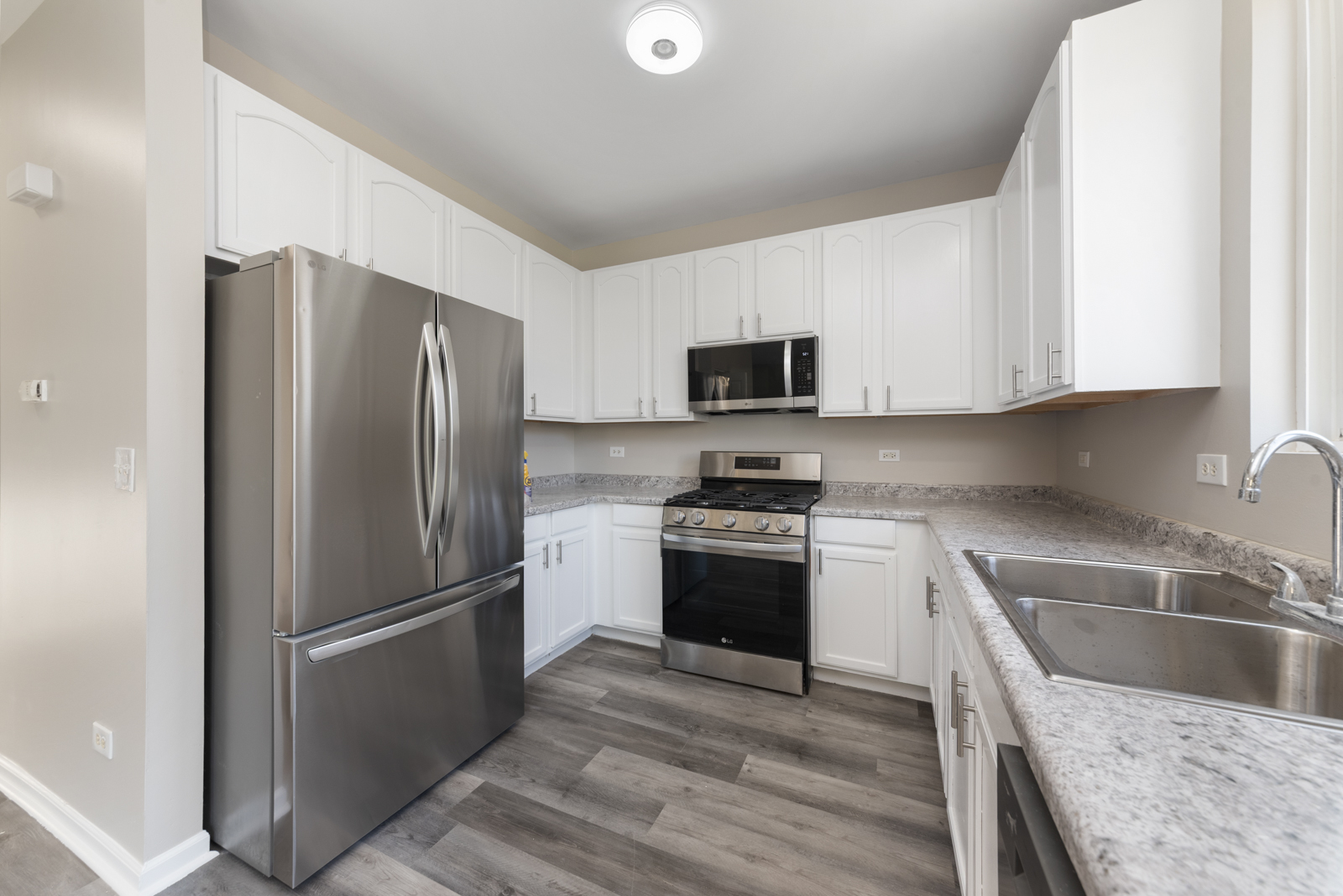 6407 Coyote Ridge Court Plainfield, IL 60586 - Photo 3 of 24 a kitchen with stainless steel appliances granite countertop a refrigerator stove and sink
