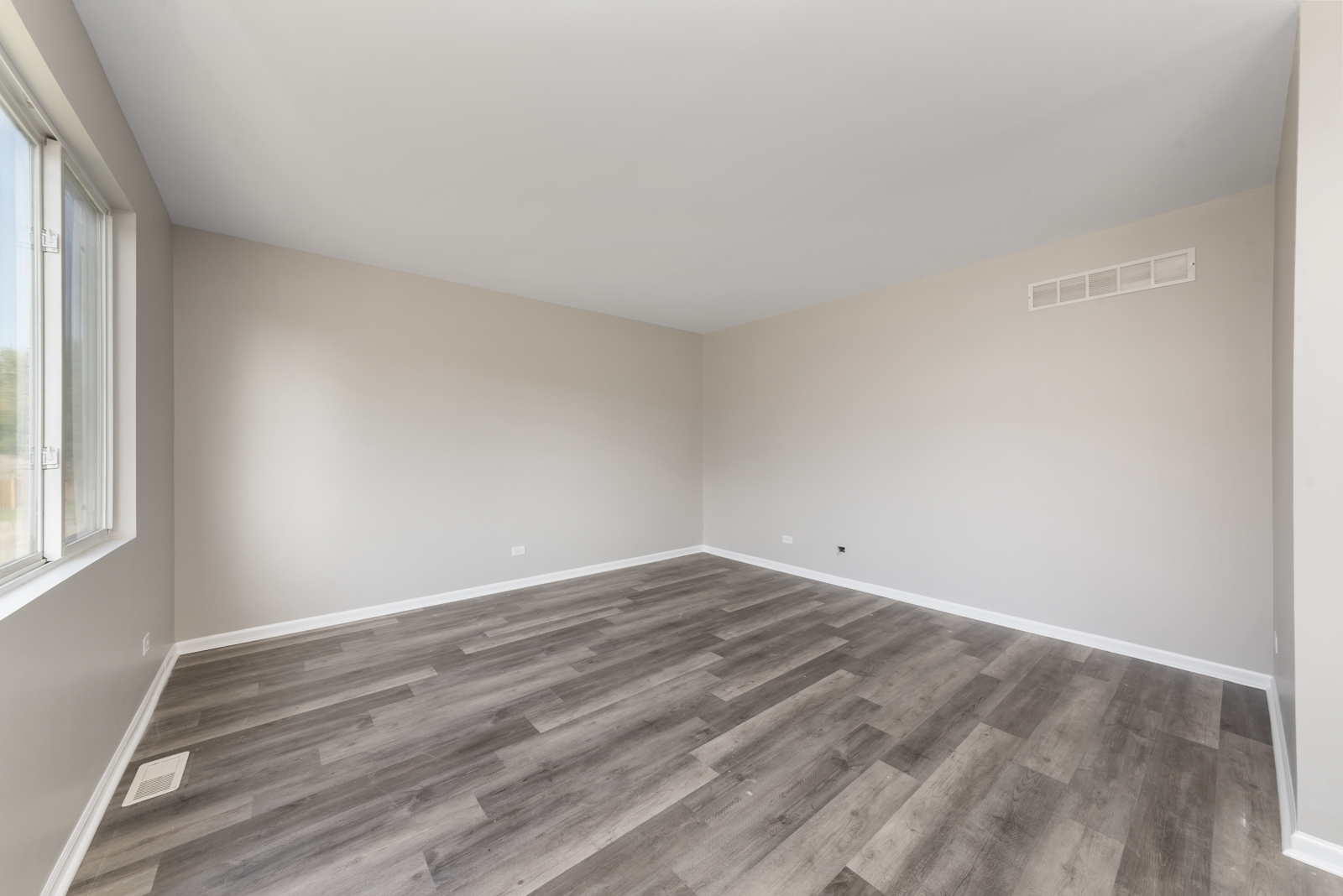 6407 Coyote Ridge Court Plainfield, IL 60586 - Photo 6 of 24 an empty room with wooden floor and windows
