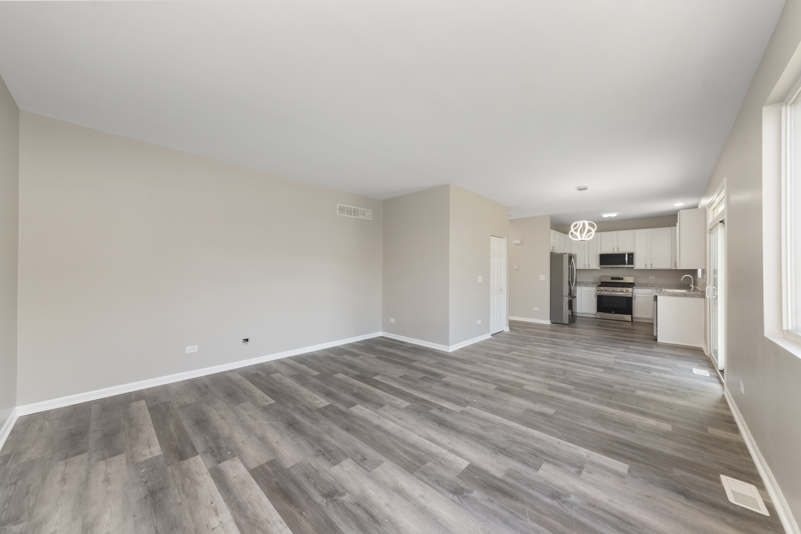 6407 Coyote Ridge Court Plainfield, IL 60586 - Photo 7 of 24 a view of a kitchen with a sink and a refrigerator