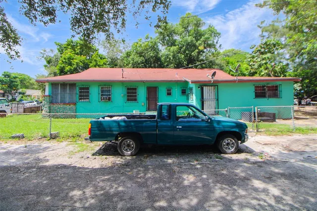 an outdoor view of a house with a garden