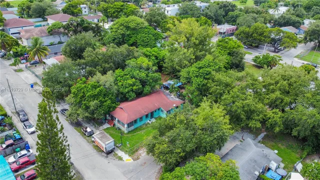 an aerial view of a house with a yard and lake view