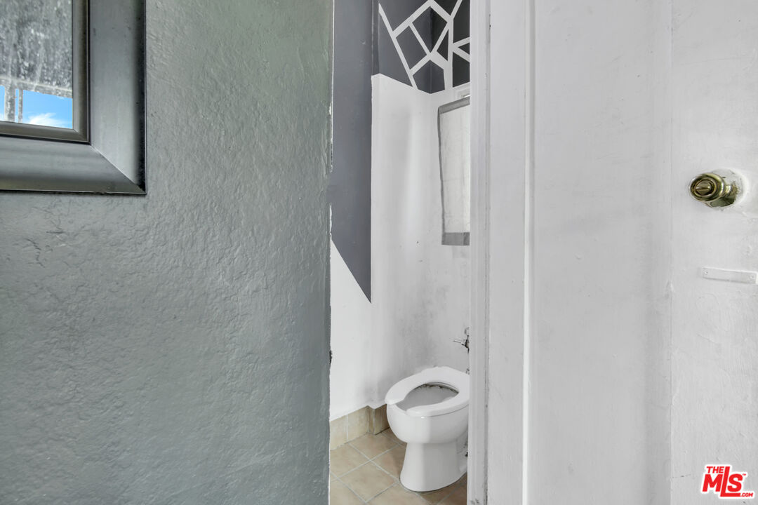 1042 Wilcox Avenue Los Angeles, CA 90038 - Photo 8 of 24 a white toilet sitting next to a bathroom sink