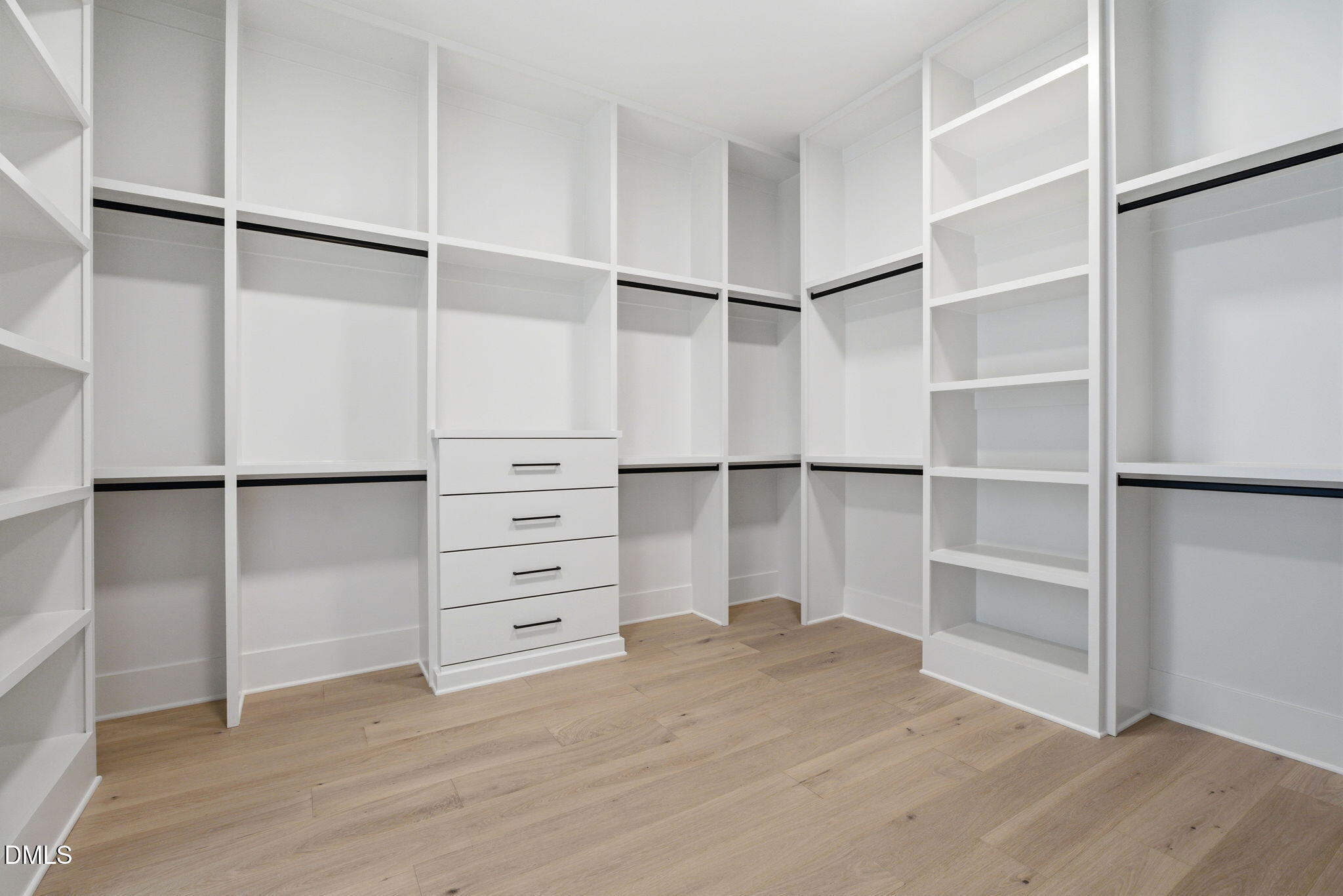 1304 Sanctuary Pond Drive Raleigh, NC 27606 - Photo 24 of 52 a view of walk in closet with empty racks